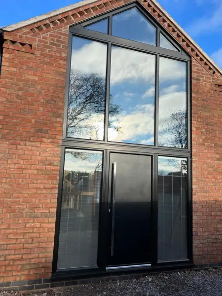 Black shaped frames with composite door and units with blinds.: Swipe To View More Images