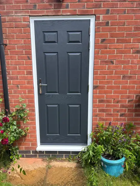 Slate grey composite door for a garage.: Swipe To View More Images